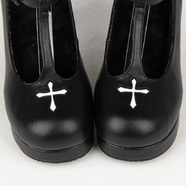 Pair of Gothic Lolita T-strap high heel shoes viewed from top-down frontal position, smooth black leather construction, prominent white cross on rounded toes, neat texture detail
