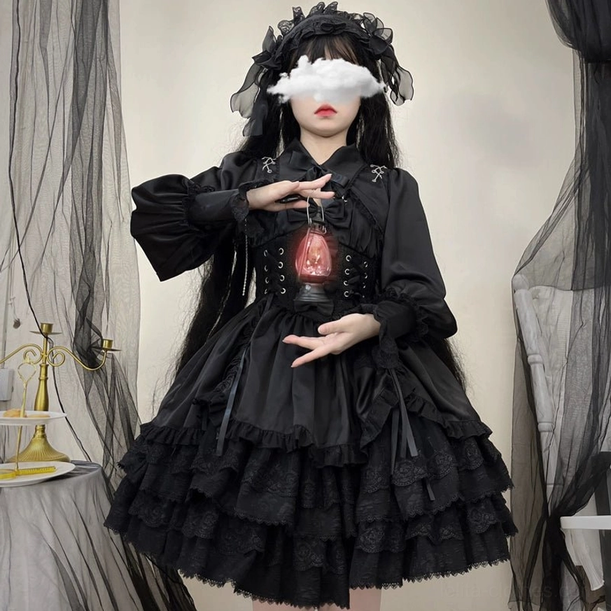Black Cross Medal Gothic Lolita dress and bolero set with vintage red lantern prop, chest cross ornament visible, gothic headdress, and dark studio theatrical setting