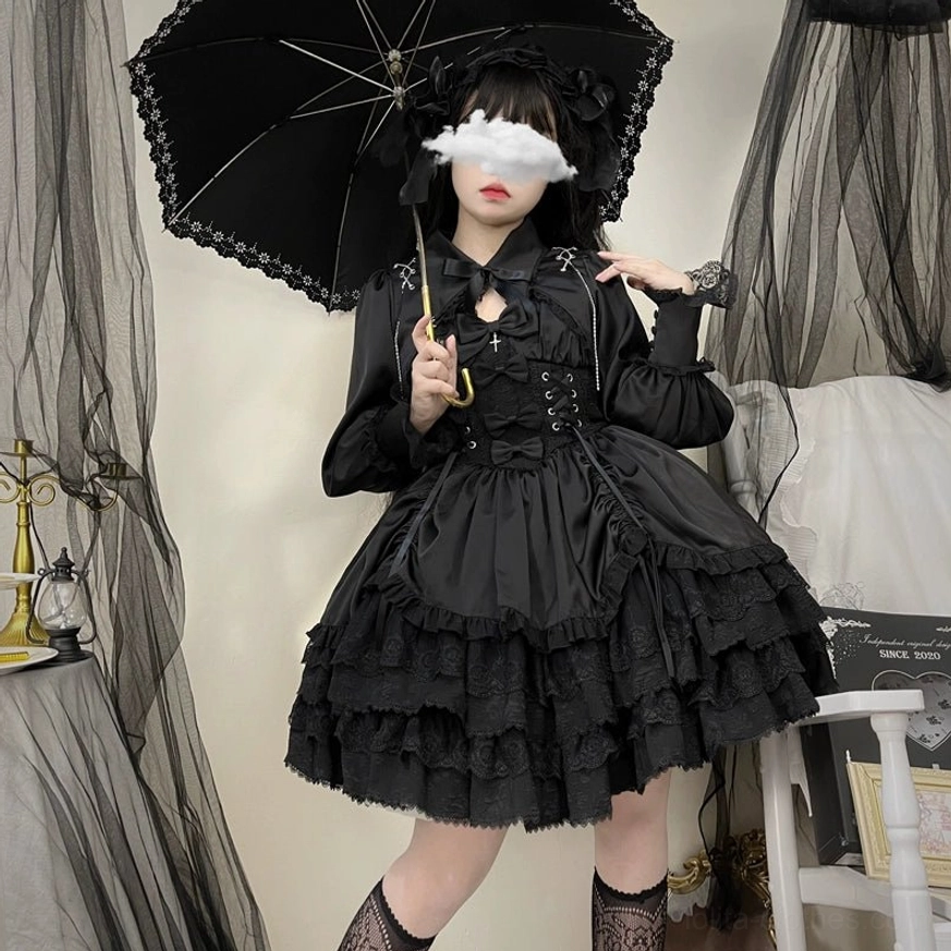 Black Cross Medal Gothic Lolita dress coordinate styled with fishnet stockings, lace-trimmed parasol, gothic headdress, and dark vintage studio setting for complete lolita look