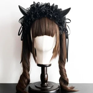 Front view of Gothic Lolita devil horn KC headdress on mannequin head with twin curly brown wig, showcasing multi-layer black ruffled lace and glossy black devil horns against white background