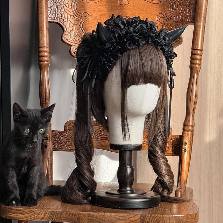 Gothic Lolita devil horn KC hairband paired with vintage Victorian chair in complete lolita fashion styling scene for authentic coordinate inspiration