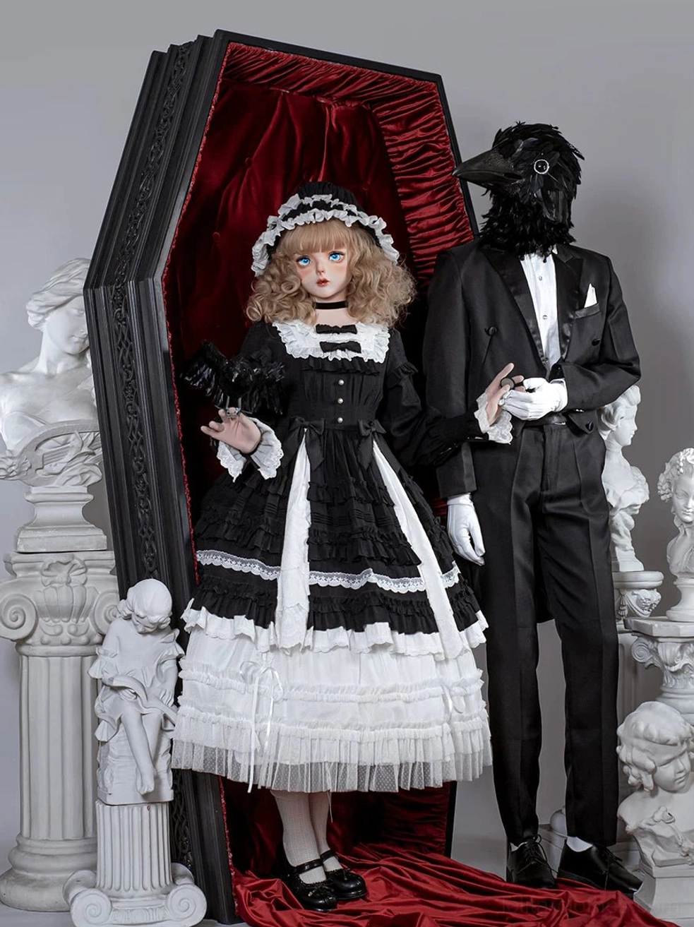 Gothic lolita dress back view showing black and white color block, frilled collar, tiered ruffled skirt details, matching hair headdress vintage coffin display