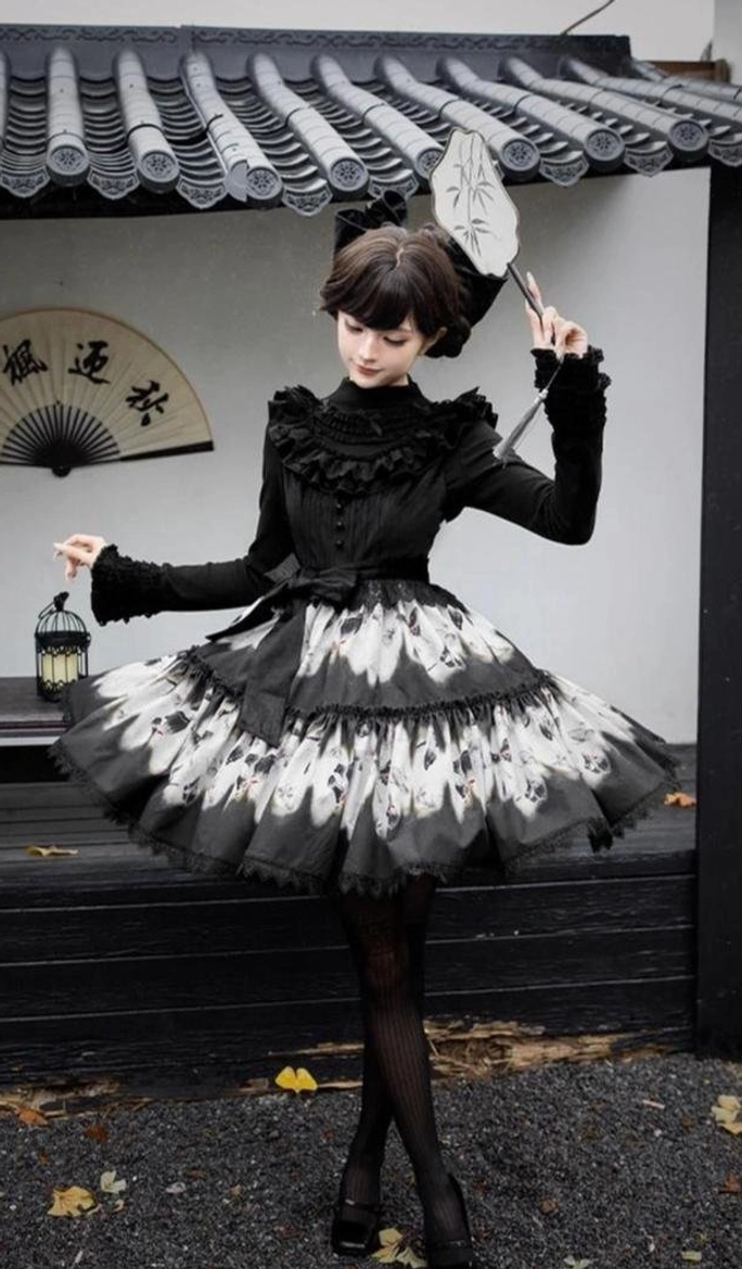 Gothic lolita dress butterfly print skirt detail tiered panels monochromatic dead leaf motif fabric layering volumetric construction