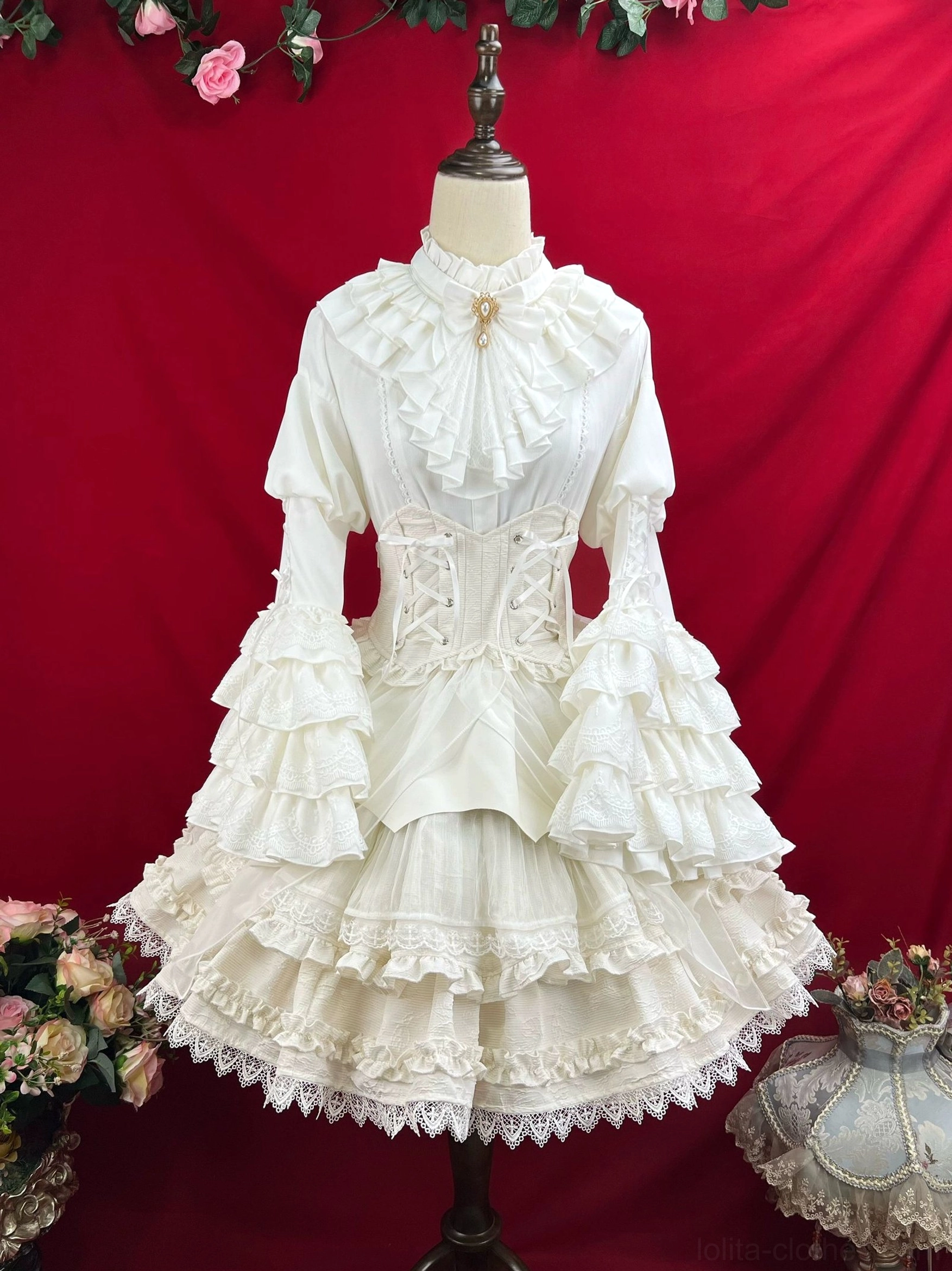 Gothic lolita dress showing corset waist definition fitted silhouette princess sleeves and architectural skirt construction with tiered ruffles and lace trim