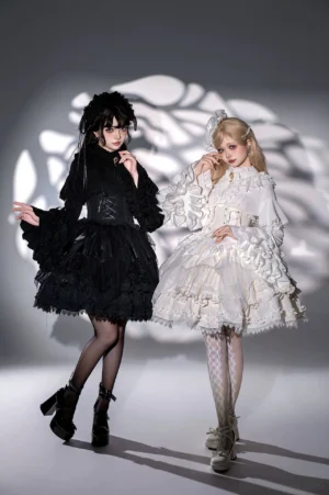 Gothic lolita dress ensemble three-quarter view showing both black corset dress and white ruffled princess dress with dramatic bell sleeves and patterned hosiery styling