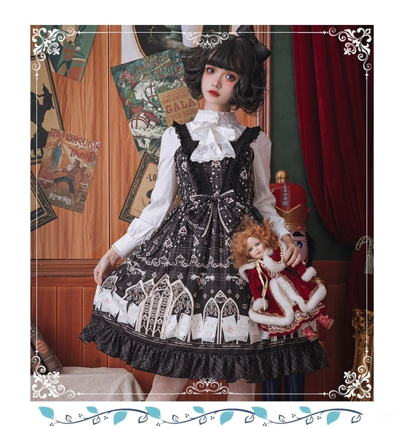 Full body side view of model wearing gothic Lolita complete outfit with white stand collar blouse under black print jumper skirt in retro studio with velvet curtains