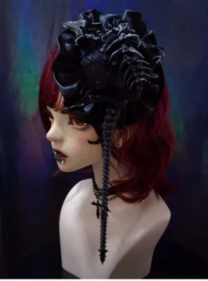 Gothic lolita headdress with spiky skeleton flower decoration and cross pendant tassel worn on BJD doll with burgundy hair, left side profile view