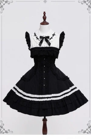 Gothic lolita black white contrast JSK jumper skirt front view with doll collar satin bow ruffled lace hem on mannequin