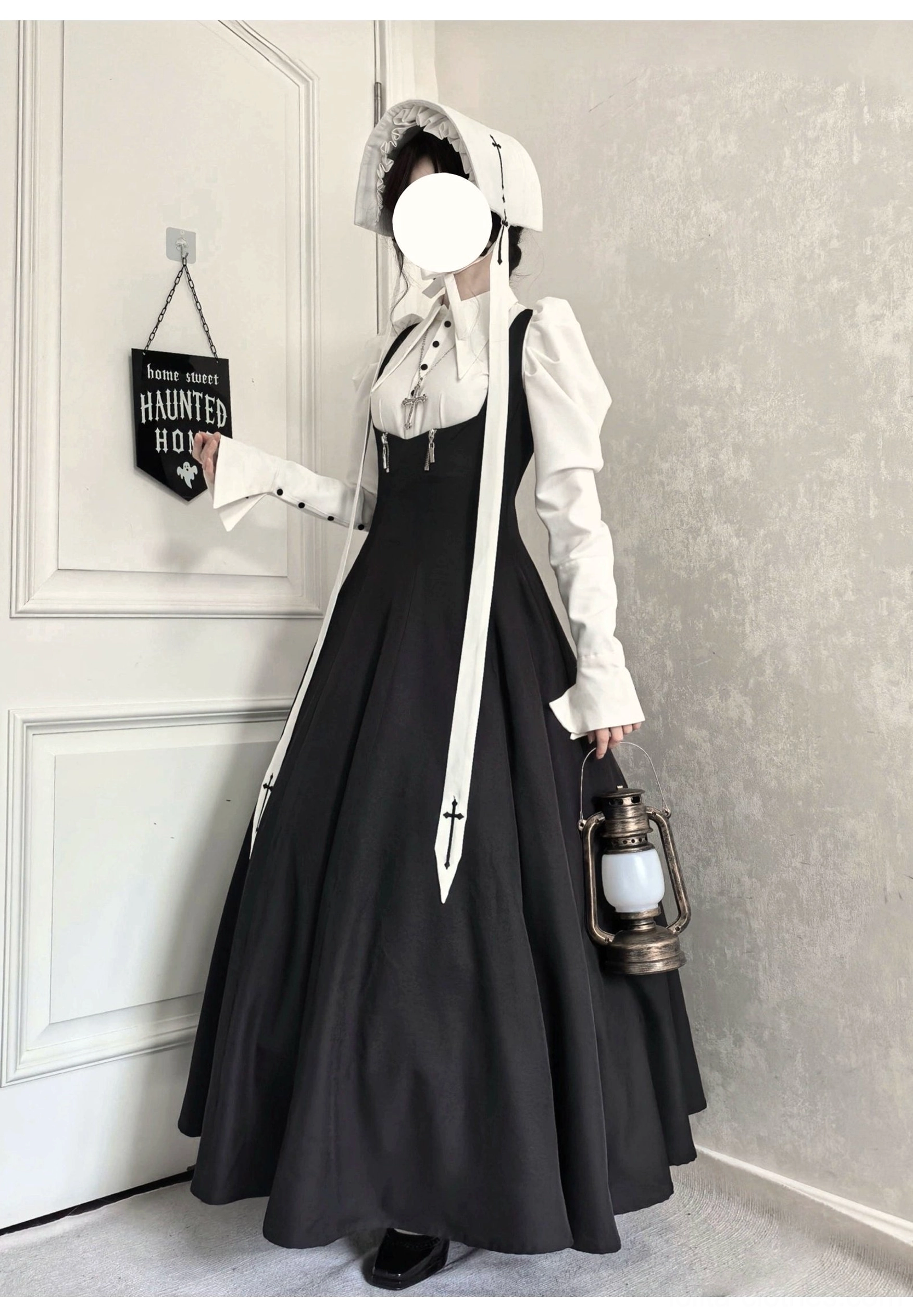 Three-quarter front view of gothic lolita JSK and blouse set with vintage lantern, black JSK with buttoned straps and white puff-sleeve blouse