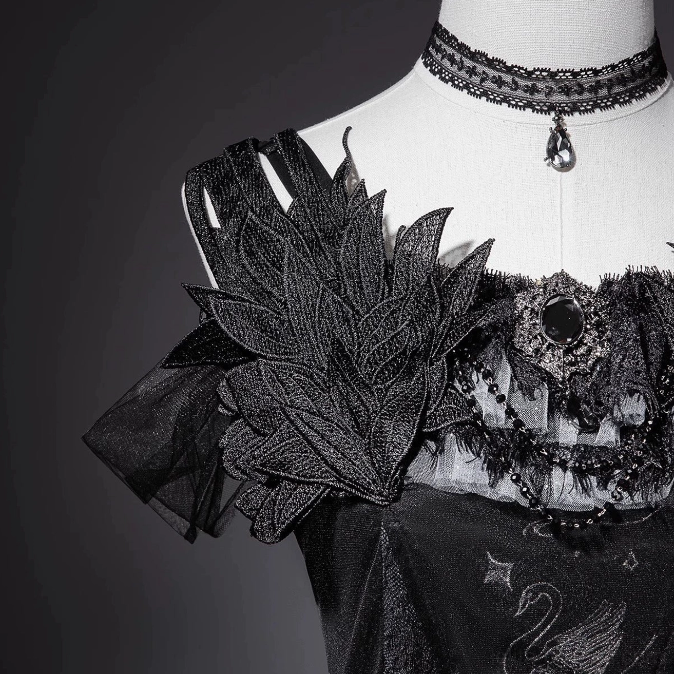 Black gothic lolita JSK dress styling reference showing complete coordinate worn by model at convention or photo event with matching accessories