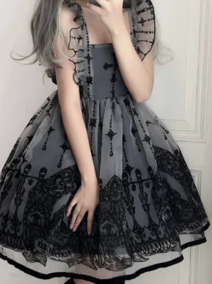 Gothic lolita JSK jumper dress with embroidered cross and vintage portrait patterns in grey-black color featuring ruffled shoulder straps and flared tulle skirt detail close-up view