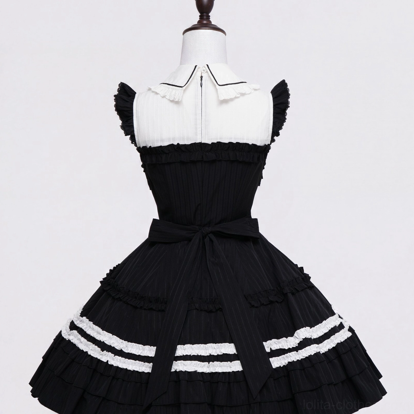 Gothic lolita ruffled JSK dress doll collar waist bow detail back display on wooden mannequin vertical pleated texture