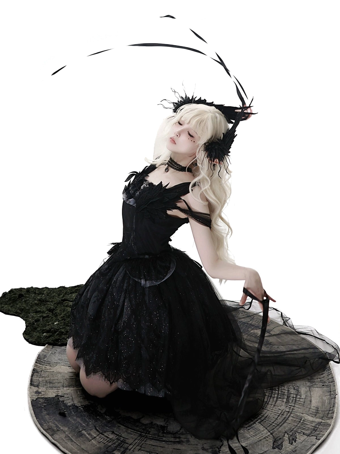 Black gothic lolita JSK dress feather hair accessory detail showing gothic styling element that coordinates with swan embroidery motif and complete coordinate aesthetic