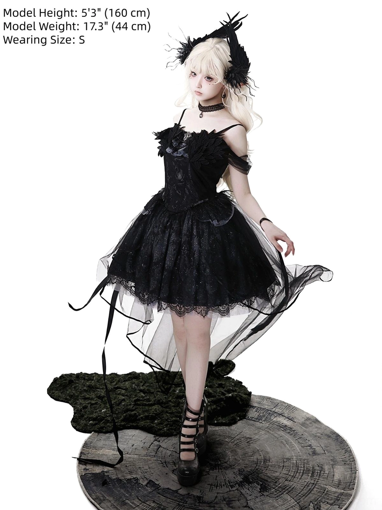 Black gothic lolita jumper skirt side-front view on model wearing size S, height 5'3 (160cm), showing off-shoulder lace dress with flowing sheer tulle high-low skirt and wrist straps
