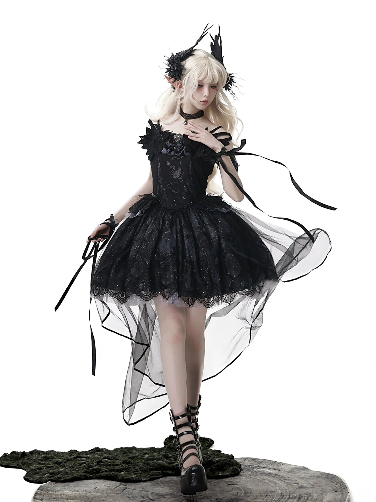 Black gothic lolita JSK dress detail shot highlighting swan embroidery at waist, glitter tulle hem sparkle, and fishbone waist shaping with chain and brooch accents