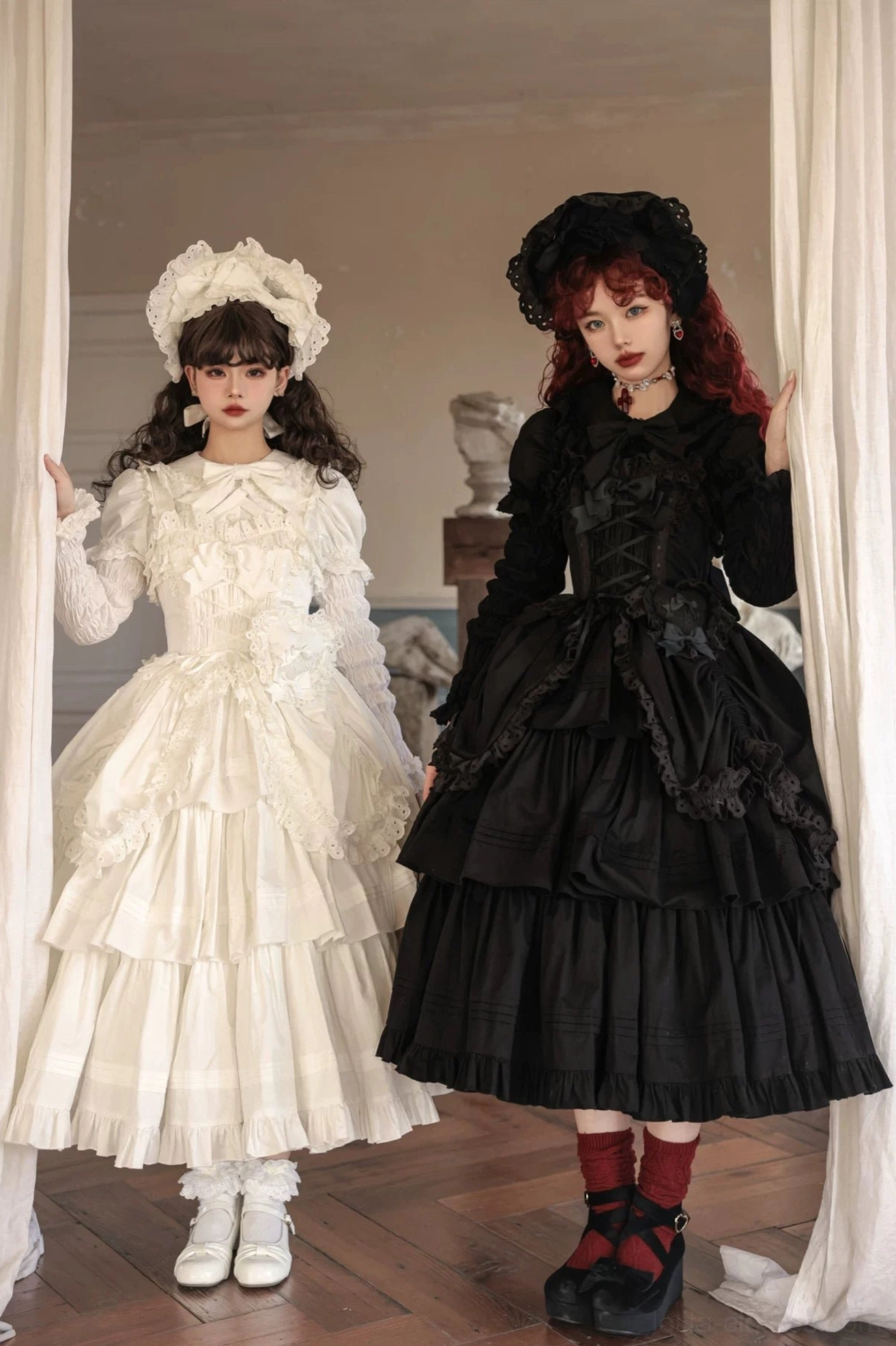 Gothic Lolita long JSK with tiered ruffles and drawn-up hem styled with off-white ruffled long-sleeve dress and black layered skirt in vintage room setting