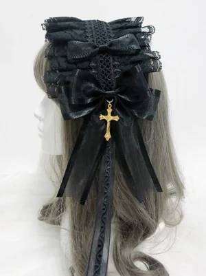 Gothic lolita KC hairband with gold cross pendant worn on mannequin, rear three-quarter view showing layered black lace, large satin bow, flowing ribbon tails, and ornate cross charm detail