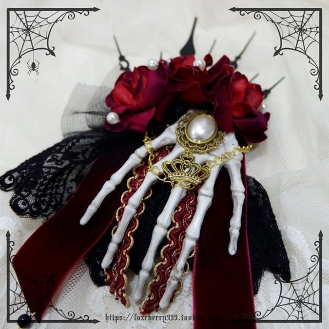 Large gothic rose skeleton hand hair ornament close-up burgundy roses white skeleton hand gold filigree velvet ribbon