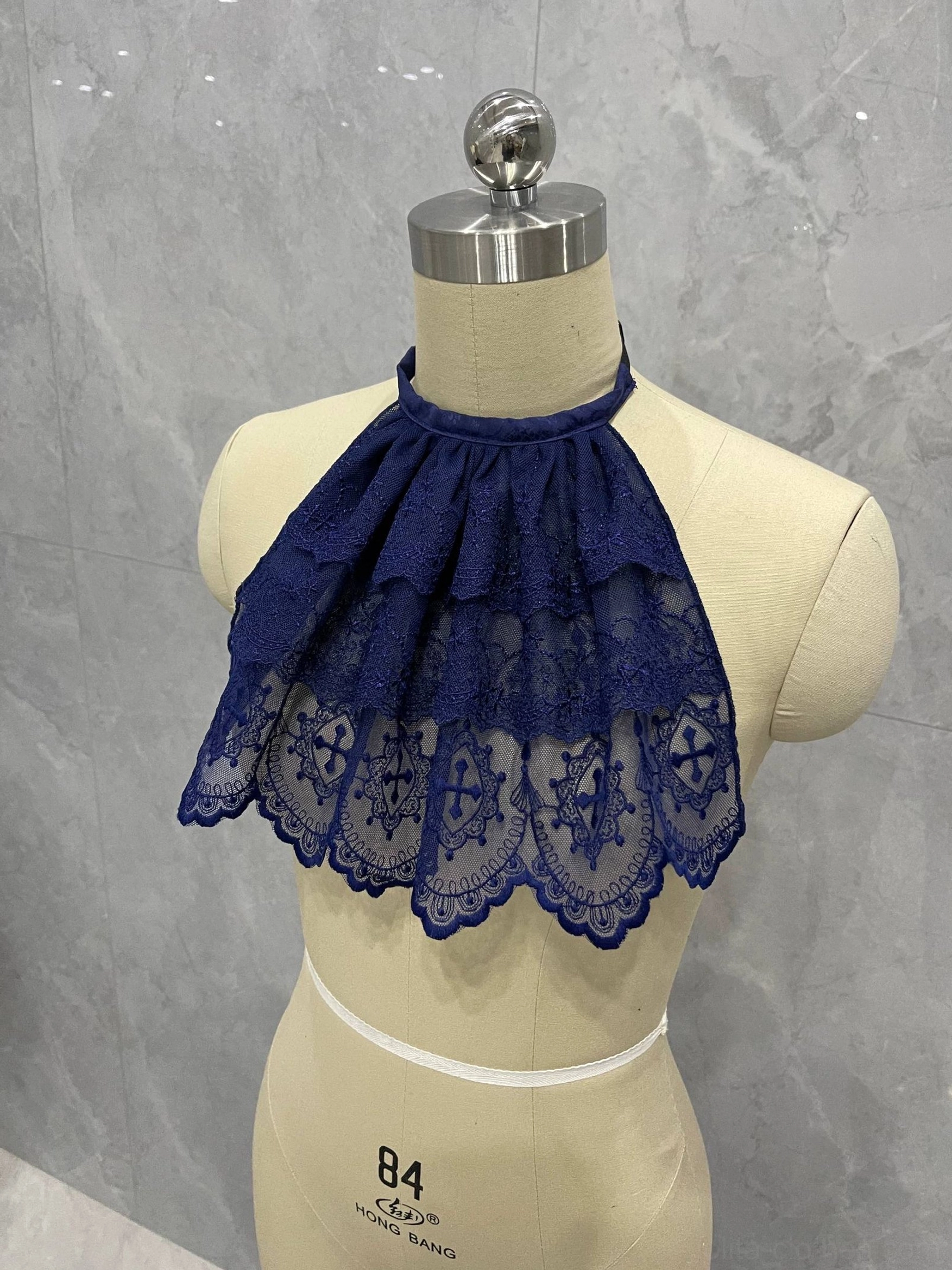 Close-up of deep blue Gothic Lolita lace neck bib showing adjustable halter neckline and cascading ruffled lace layers
