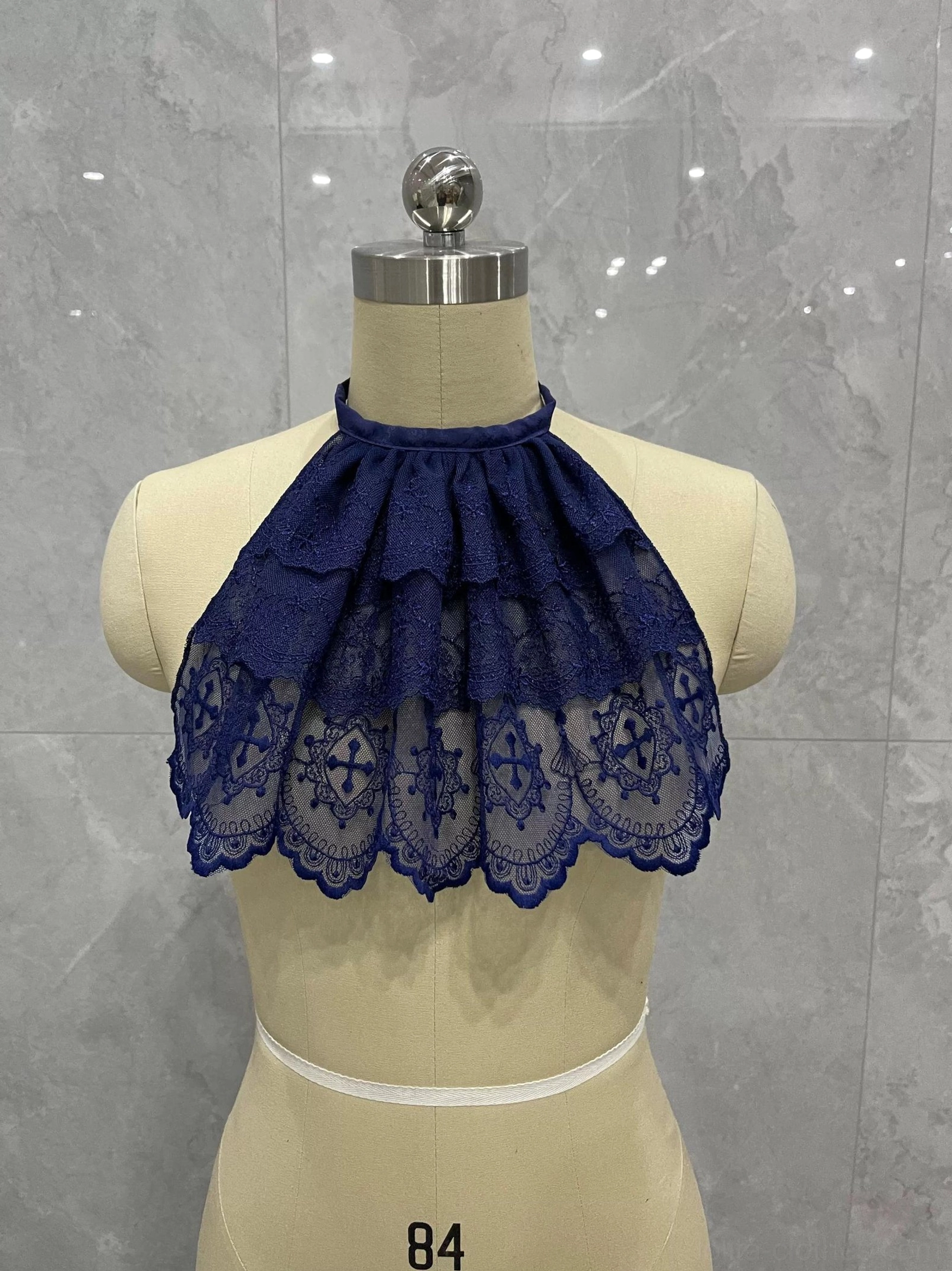 Deep blue Gothic Lolita layered lace neck bib with halter strap, ruffled tiers, cross lace trim, and scalloped hem