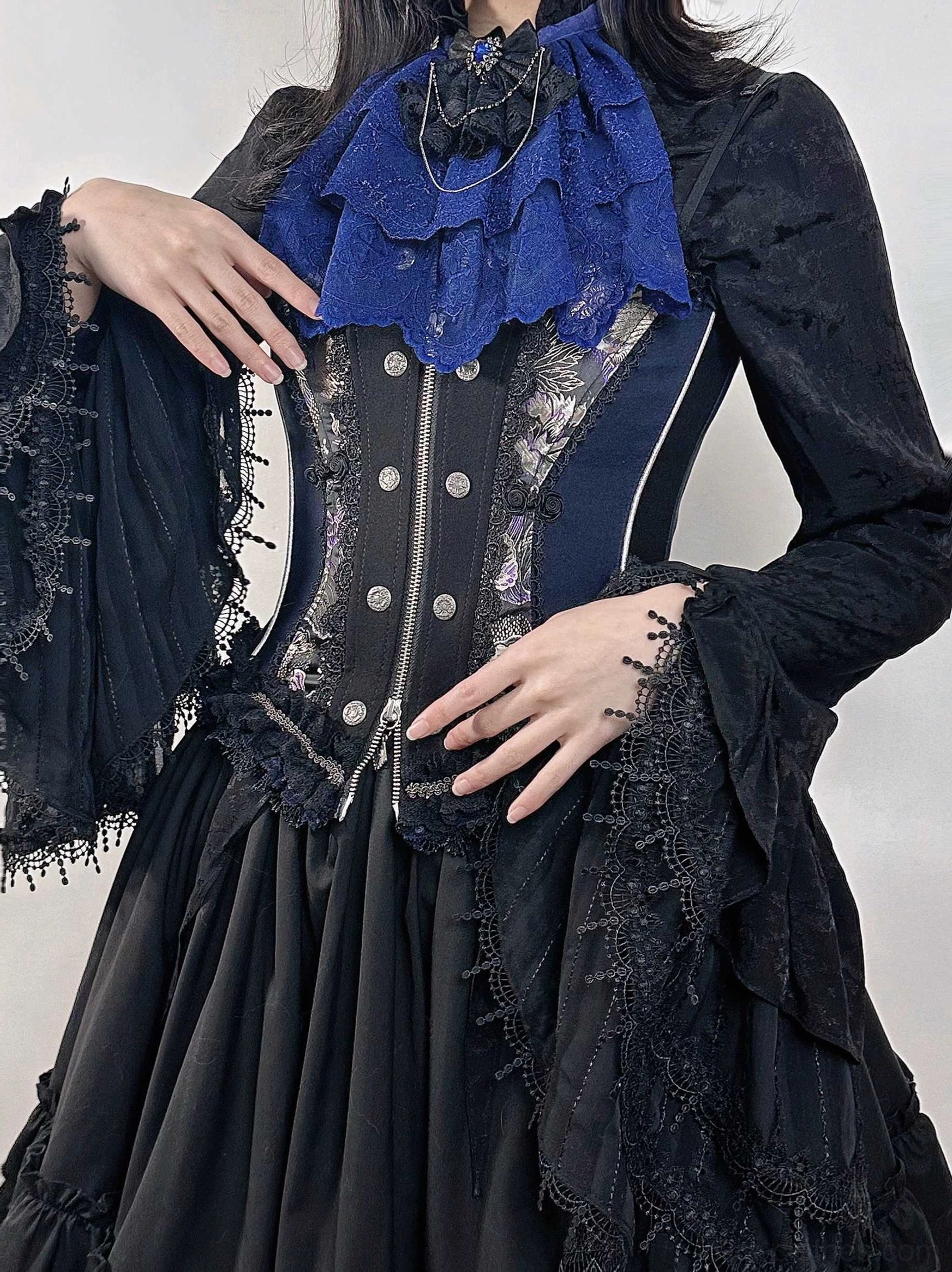 Gothic Lolita deep blue lace neck bib worn over a black corset dress, featuring layered ruffles and decorative neckline detail