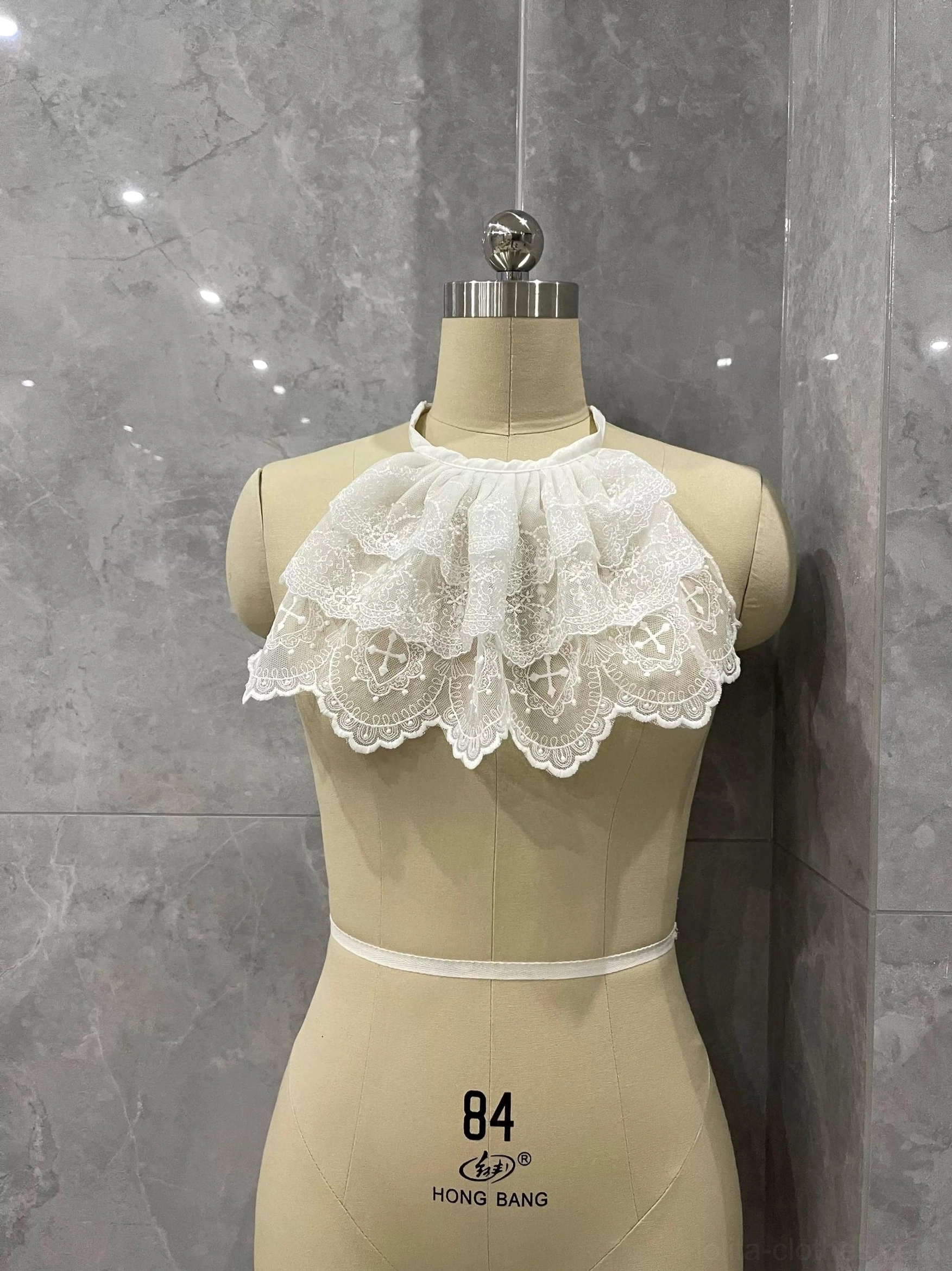 White Lolita layered lace neck bib with soft ruffled tiers, halter strap, and elegant scalloped lace hem
