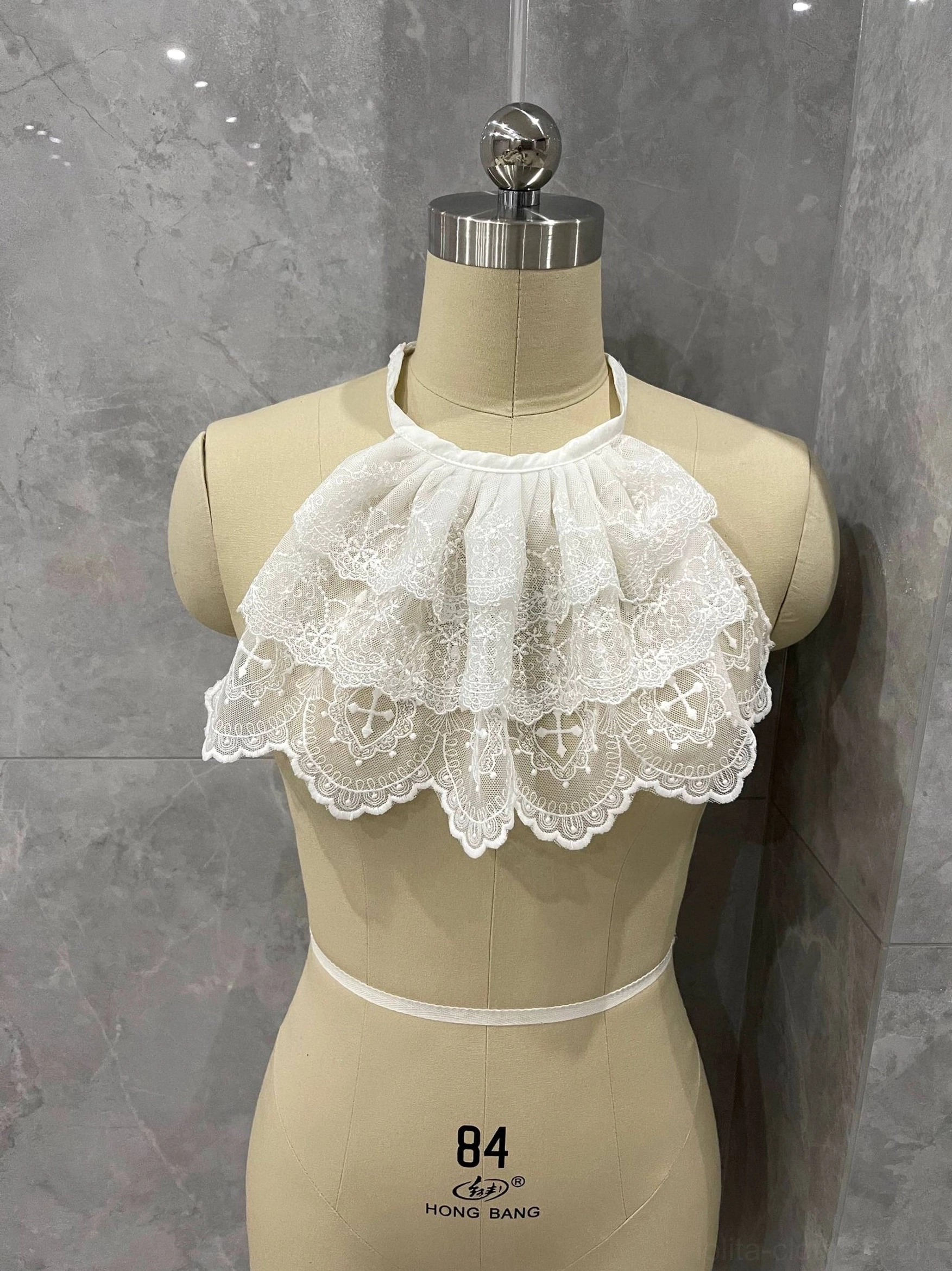 Side view of white layered lace neck bib accessory for Gothic Lolita and elegant Victorian-inspired outfits