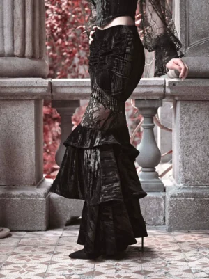 Side view of black velvet Gothic Lolita mermaid skirt displaying fitted silhouette sheer lace panel and layered fishtail ruffles