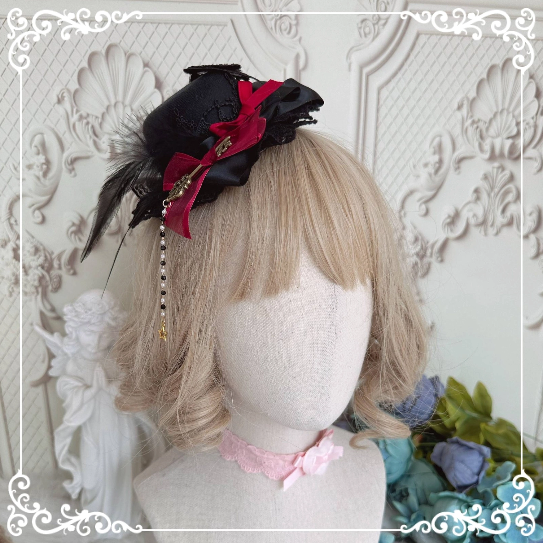 Gothic Lolita mini top hat hair accessory on mannequin head with blonde wig, featuring black red color scheme, feather trim, satin bow and hanging tassel charm