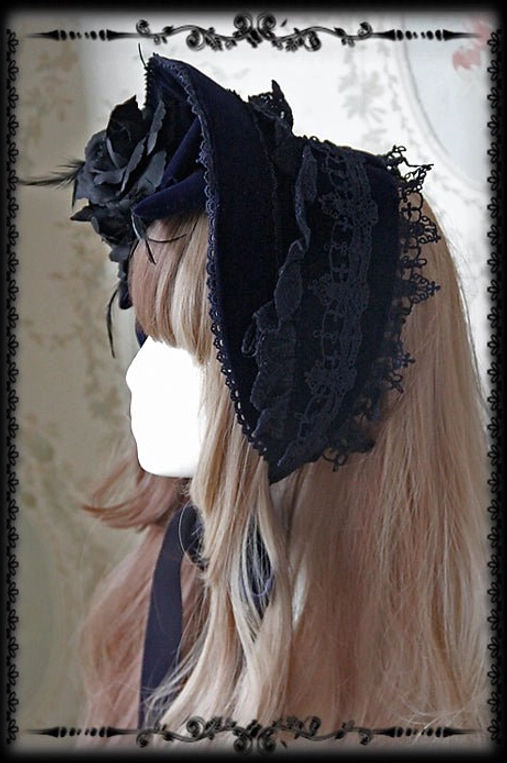 Gothic Lolita navy blue velvet bonnet with black lace frills and rose decorations, left side mannequin wearing view, adjustable headpiece
