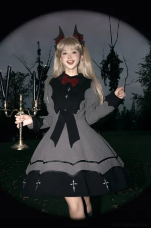 Vampire princess bat-inspired Halloween gothic lolita OP dress front view with red bow and cross embroidery on model wearing devil horns