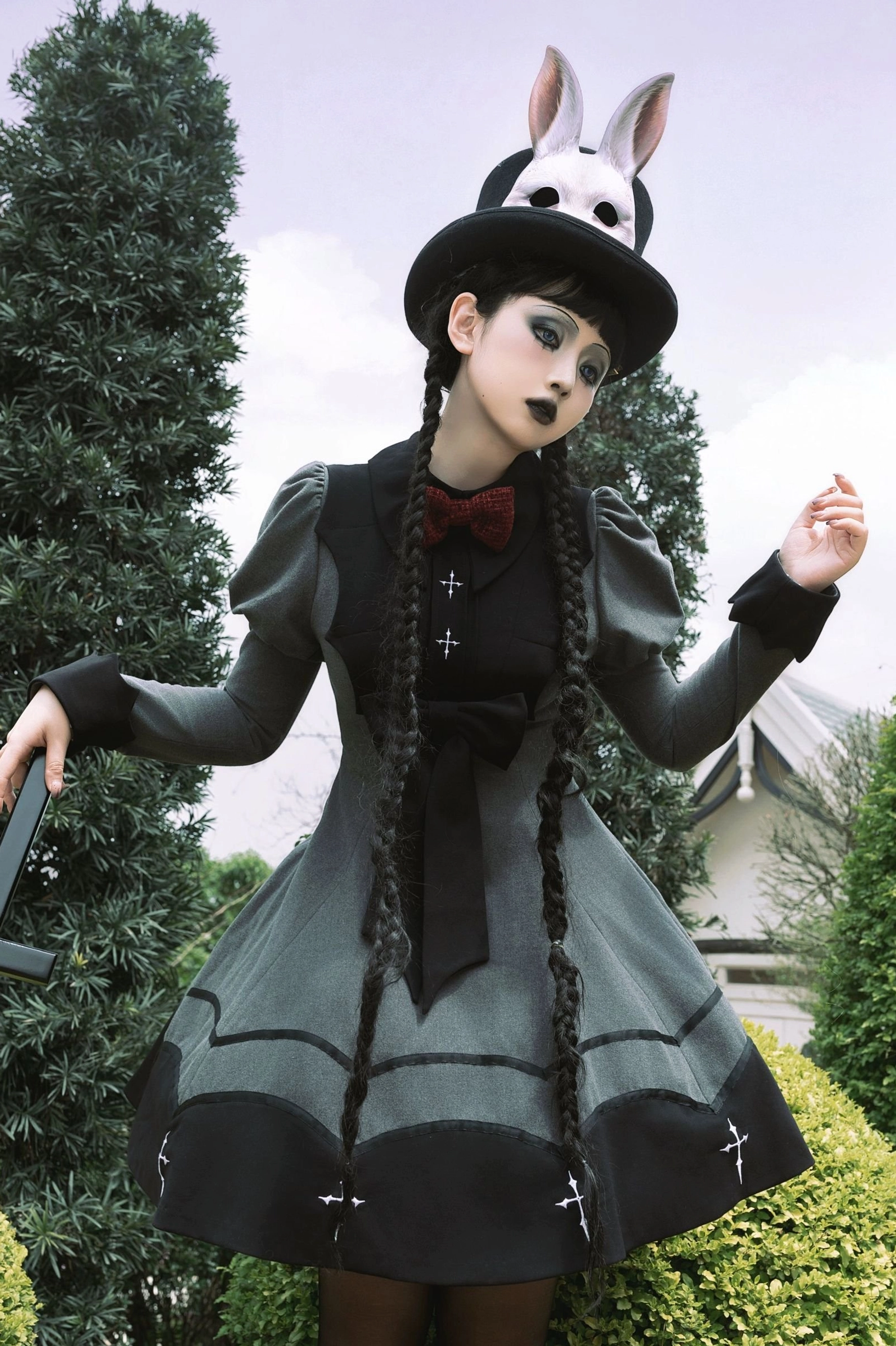 Nocturnal elegance bat-inspired gothic lolita OP dress detail shot showing intricate cross embroidery ruffled hemline