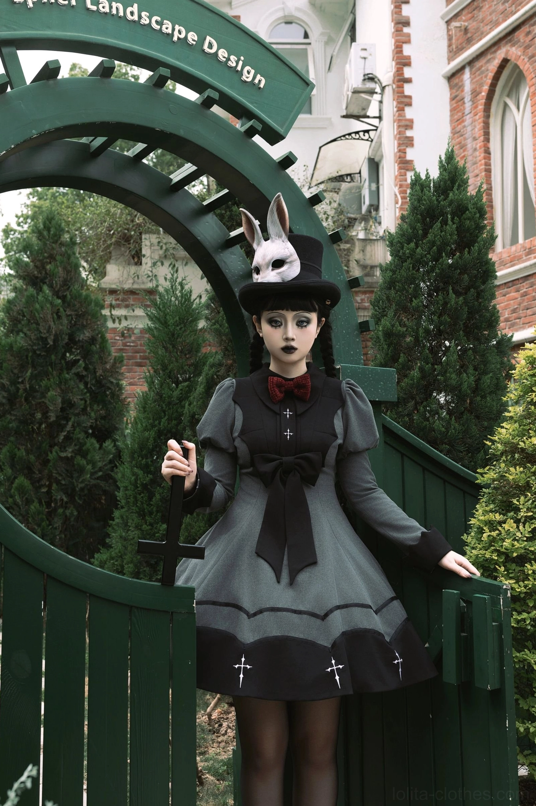 Bat-wing gothic lolita OP dress front chest black bow statement detail puffed sleeve construction close-up view