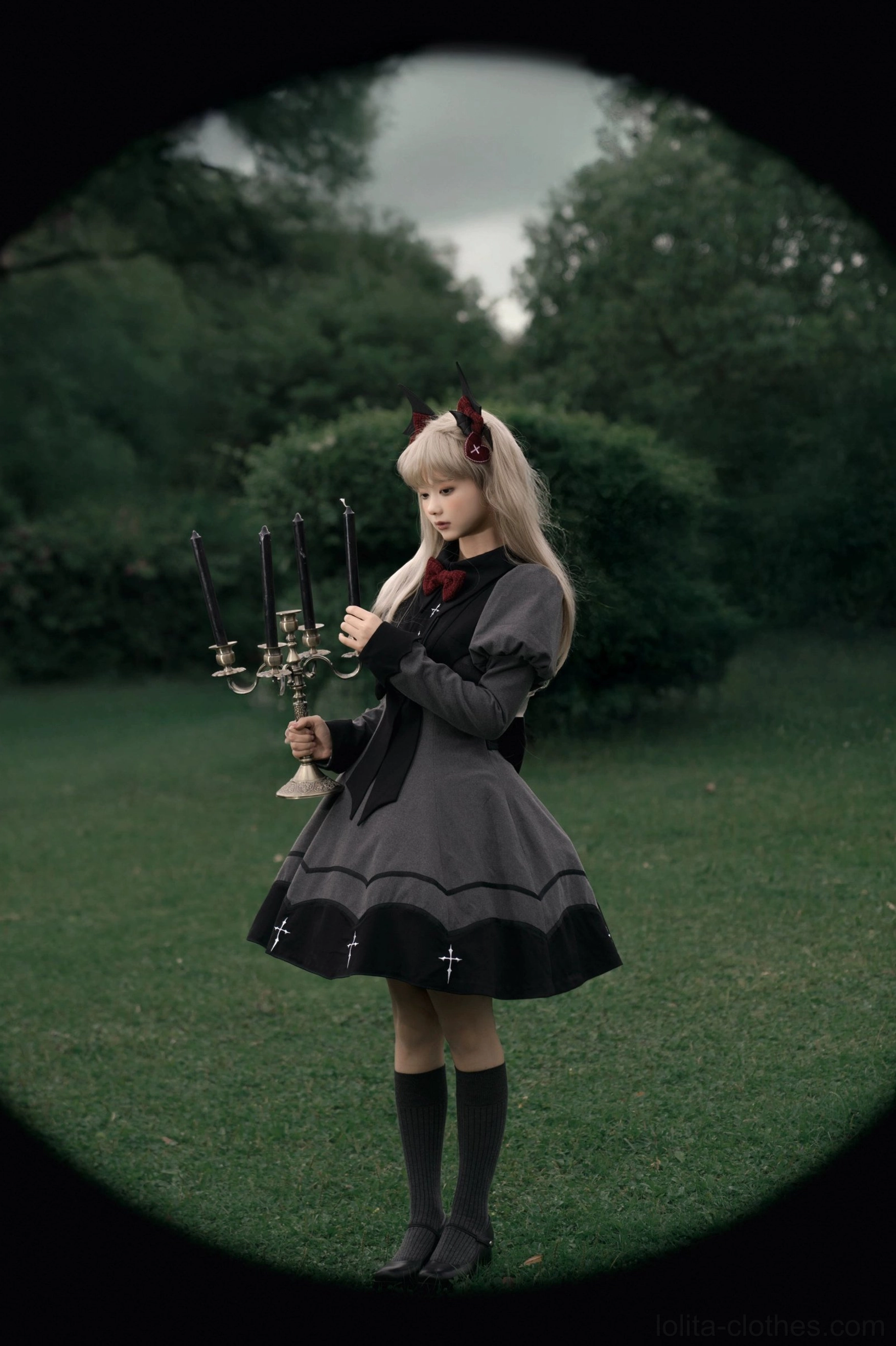 Nocturnal elegance gothic lolita OP dress side view model wearing black socks shoes holding vintage candelabra fitted waist bow