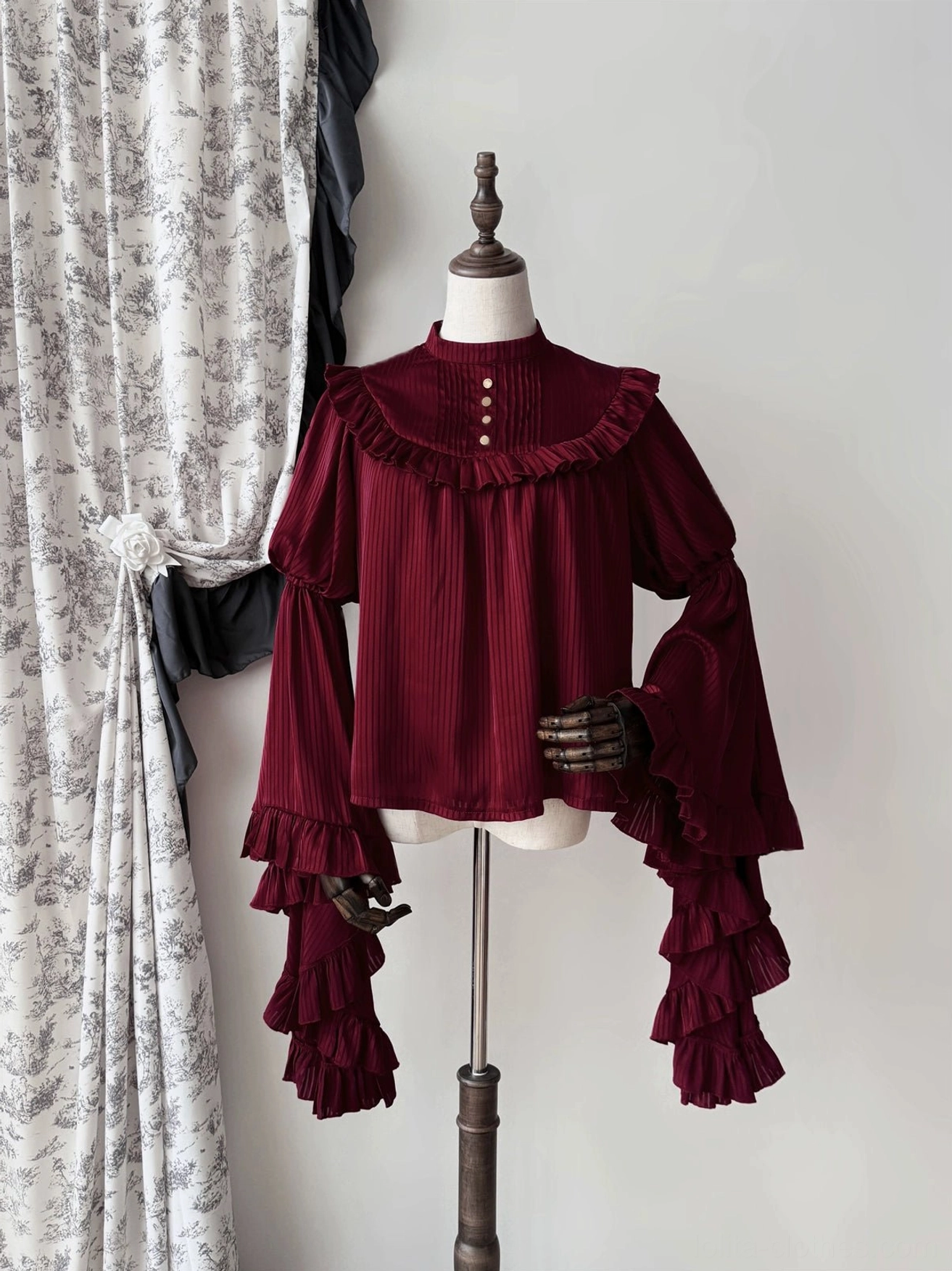 Gothic lolita princess sleeve blouse detail shot showing ruffled sleeve hem construction, button placket, and vertical stripe weave quality