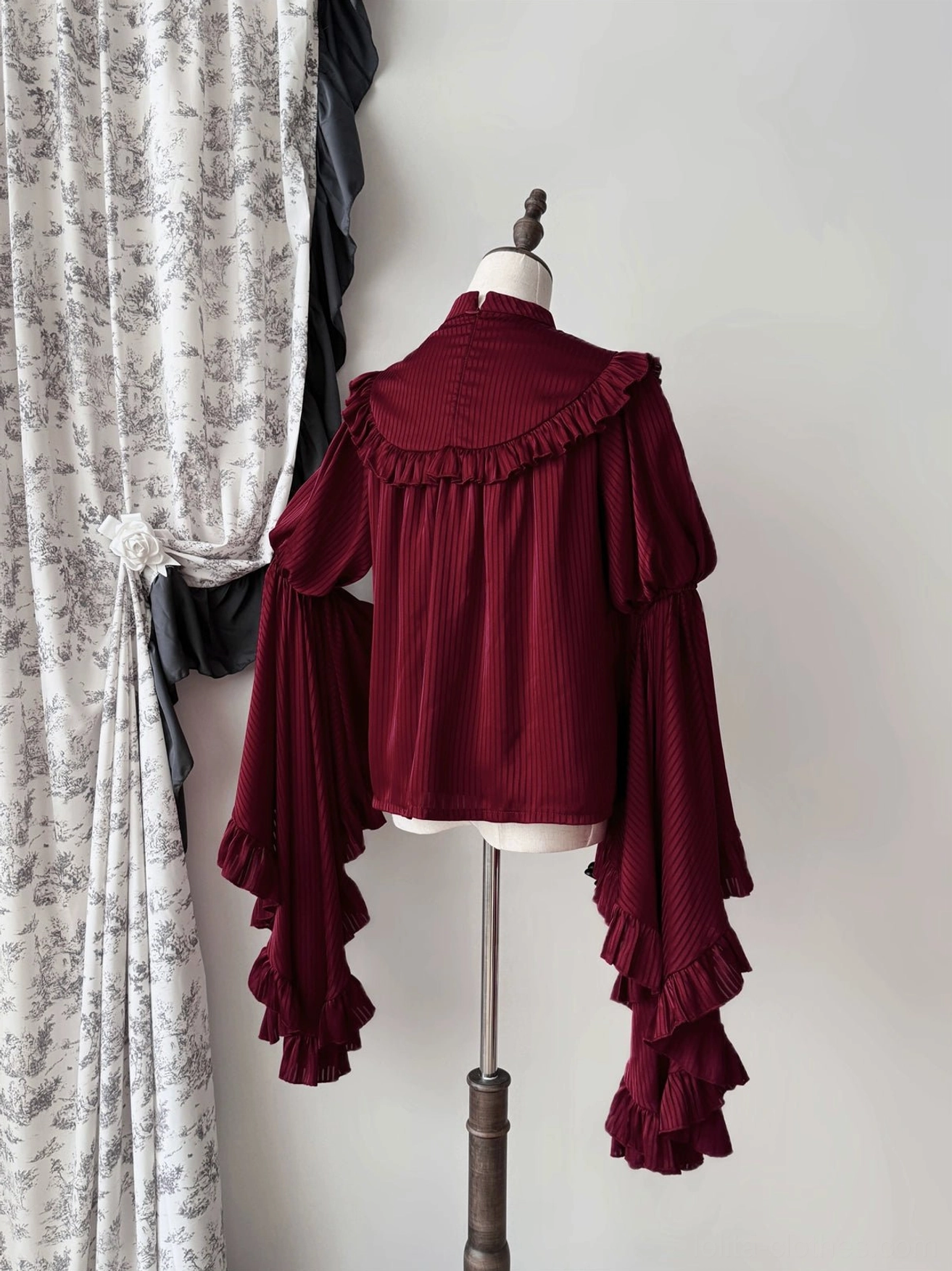 Gothic lolita striped blouse close-up of princess sleeve ruffles showing dimensional layering and pleated sheer overlay construction