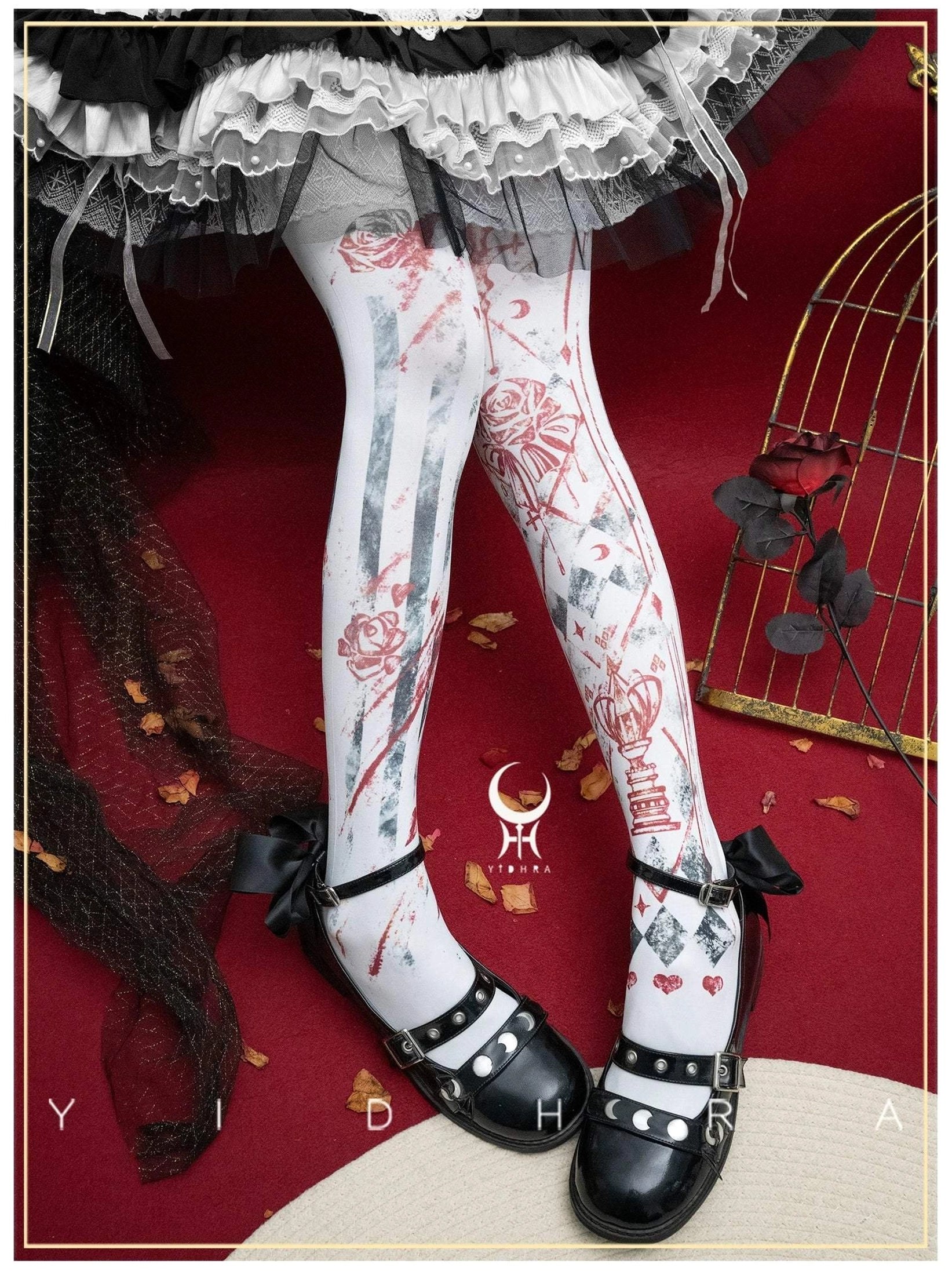 White base Gothic Lolita printed tights featuring red and grey rose card-pattern designs with gold accents styled with tiered ruffled Lolita skirt and black strap shoes