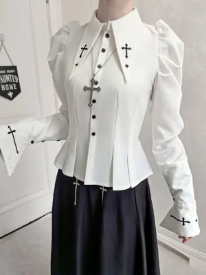 Close-up front view of gothic lolita puff-sleeve blouse with cross embroidery on collar and cuffs, structured sleeves and black JSK
