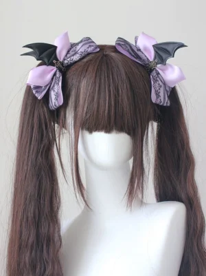 Lavender purple gothic lolita batwing hair clips with satin bows and black bat wings on mannequin head showing front view of twin ponytail hairstyle