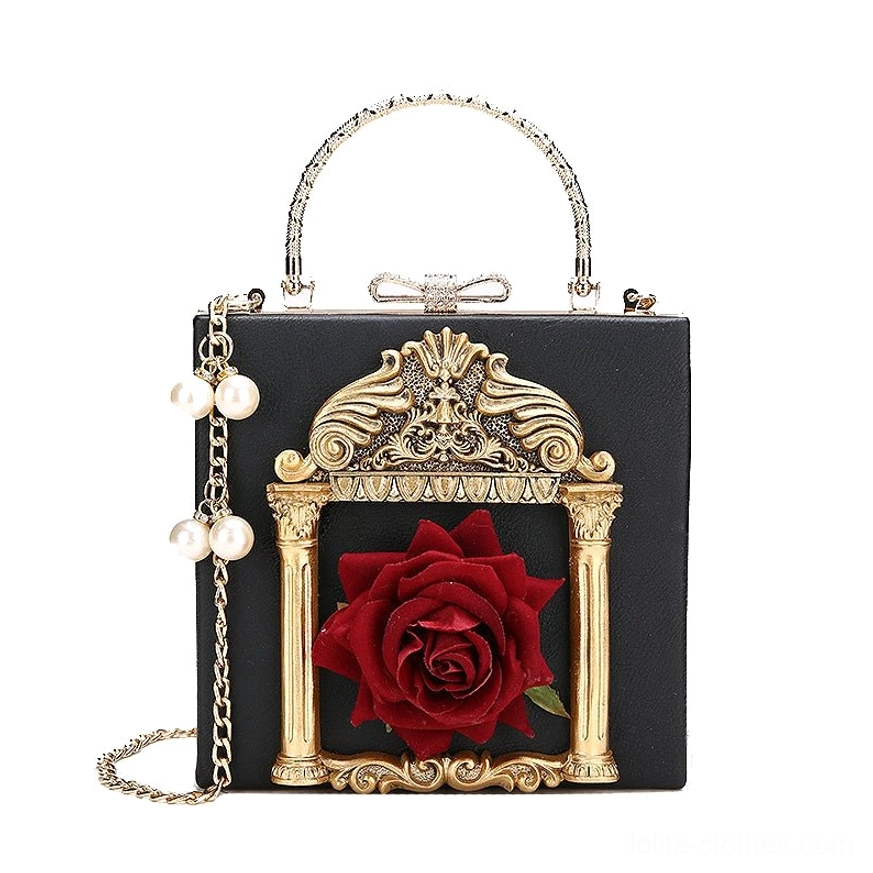 Black gothic lolita hardshell square crossbody bag standalone product view with gold baroque frame red rose silk embellishment pearl adorned chain strap