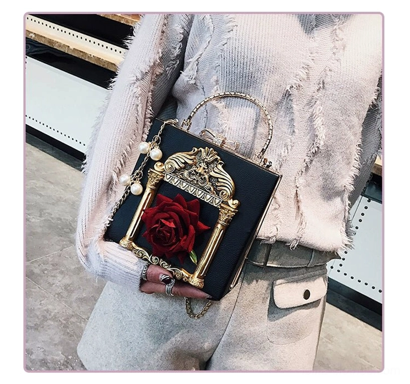 Black gothic lolita square crossbody handbag with red rose embellishment gold baroque frame and pearl chain strap styled on model front view