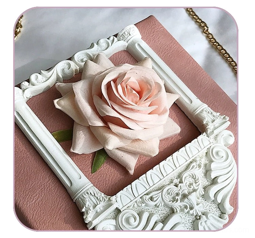 Gothic lolita square crossbody bag butterfly buckle closure mechanism ornamental metal detail close-up view