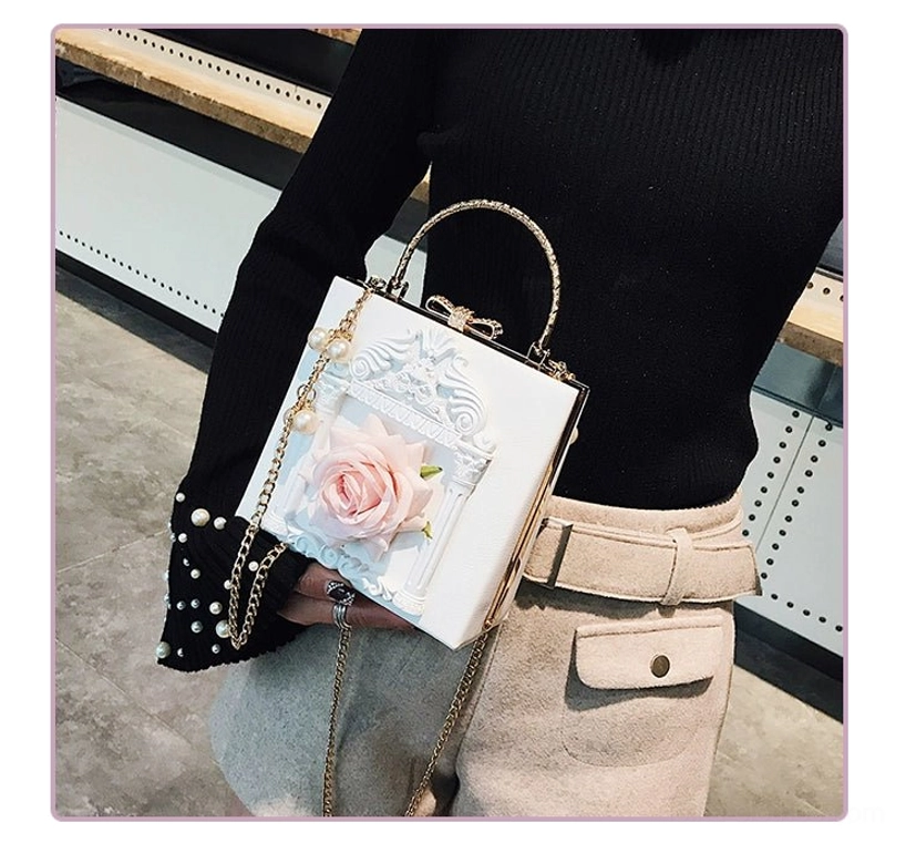 Off-white gothic lolita square crossbody bag with pink rose embellishment white carved baroque frame pearl handle detail front view styling