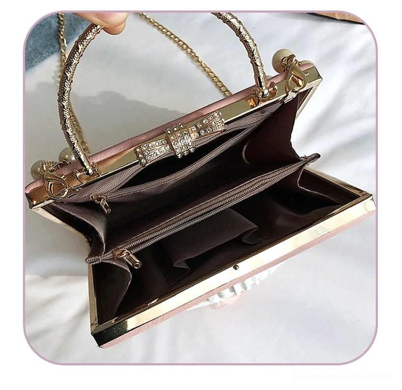 Gothic lolita square crossbody bag rear view showing metal frame structure and chain strap attachment construction details