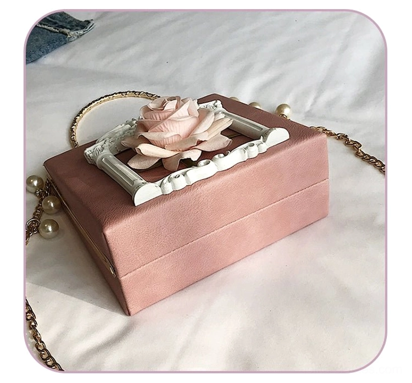 Gothic lolita square crossbody bag side profile view showing dimensional baroque frame and silk rose embellishment depth