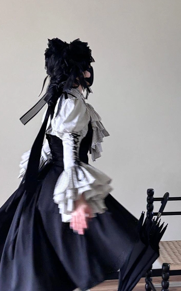 Back view of Gothic Lolita striped blouse showing adjustable cross-tie back closure with button details and high-waisted silhouette on dress form