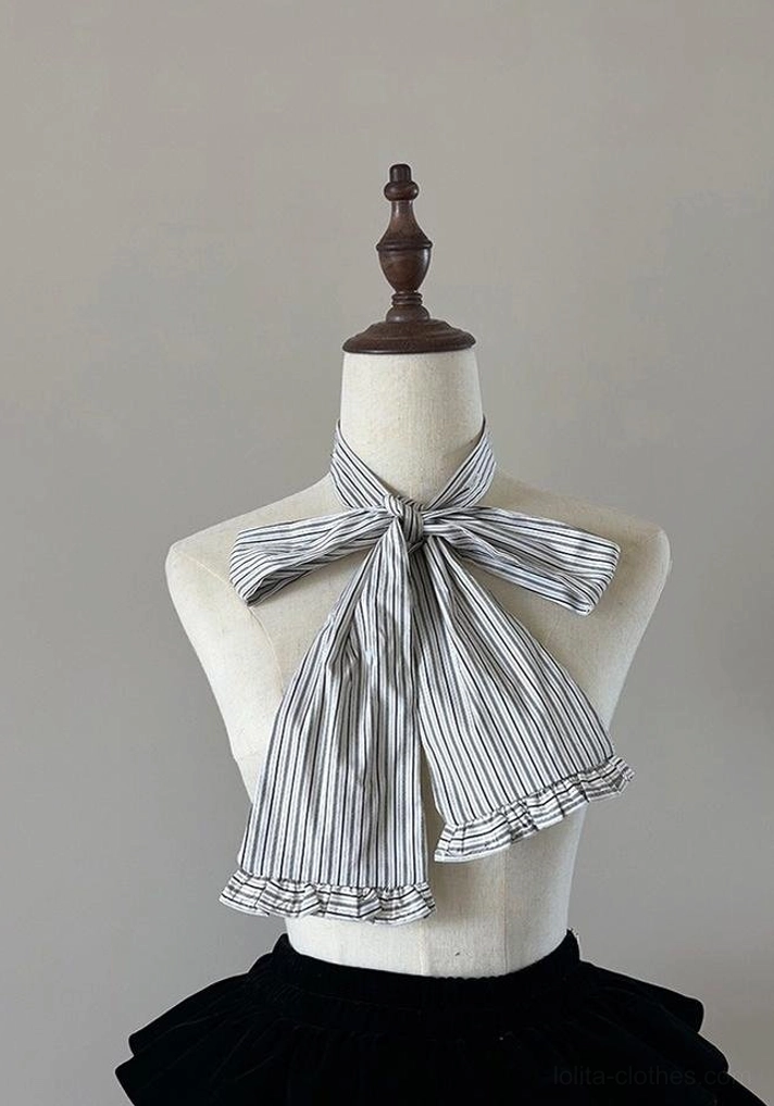Hem detail of Gothic Lolita striped blouse showing asymmetrical ruffles or layered hem construction characteristic of gothic Lolita silhouette and design aesthetic