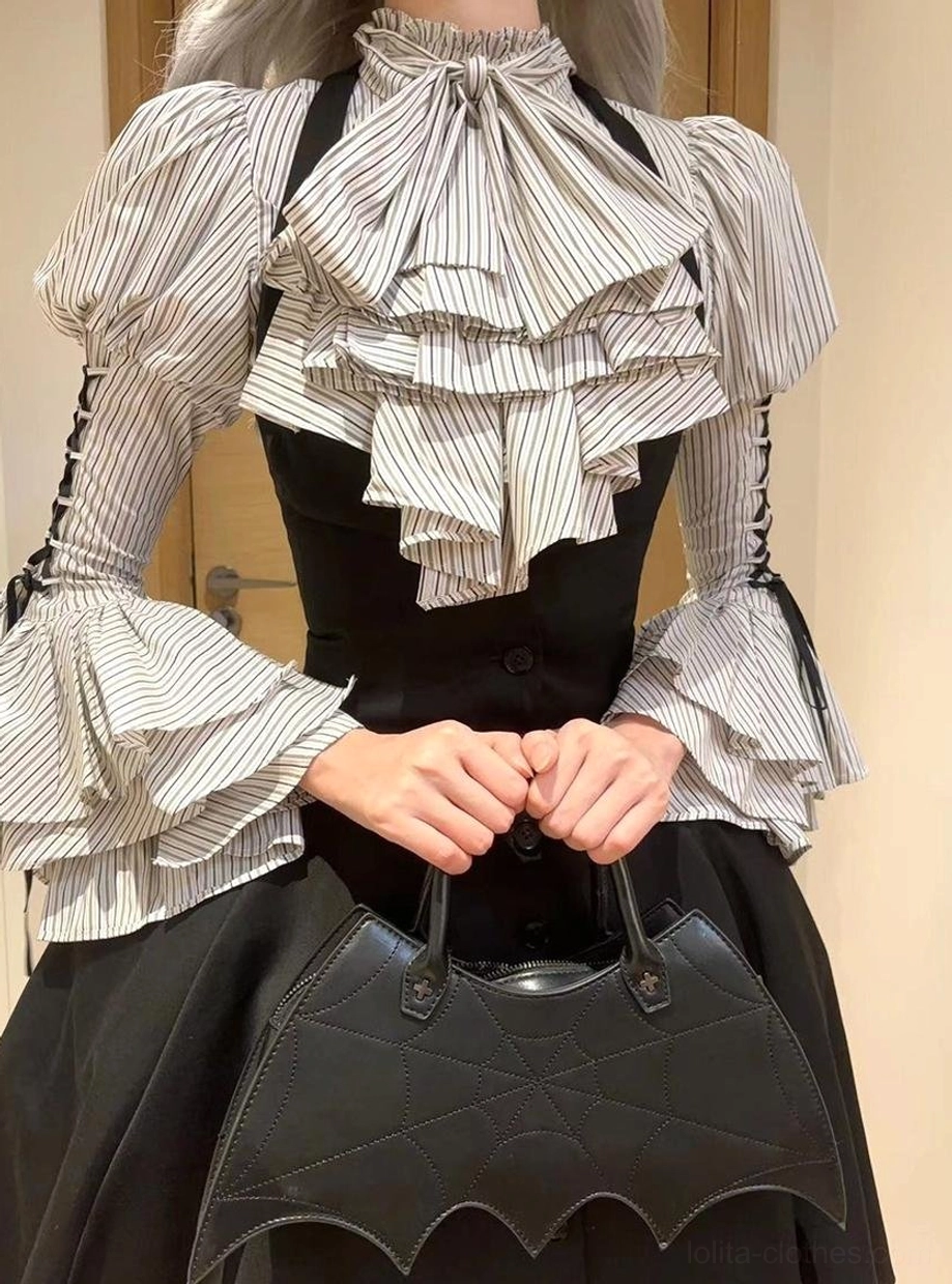 Close-up front view of person wearing Gothic Lolita striped blouse with layered ruffled jabot and lace-up decorated puff sleeves, paired with black waistcoat and black high-low skirt