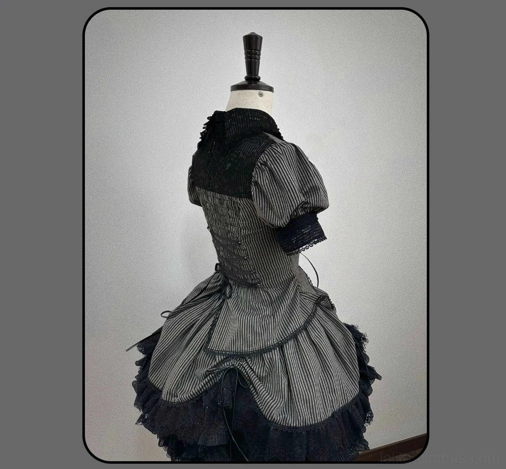 Gothic Lolita striped blouse and skirt coordinate styled for convention photography in architectural setting
