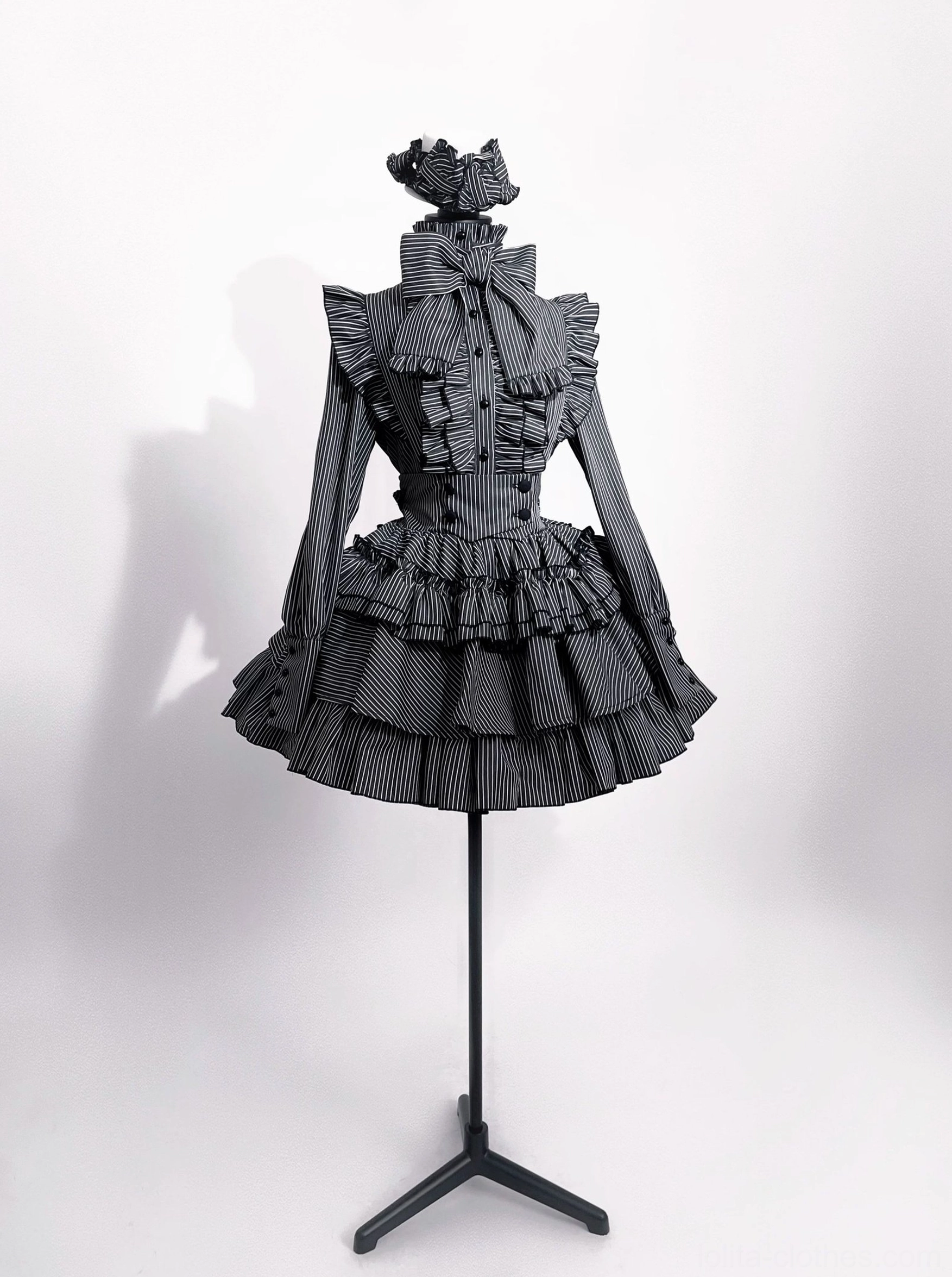 Front full view of grey striped gothic lolita suit on dress form mannequin, displaying fitted silhouette, ruffled collar and layered tiered skirt without model